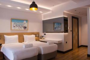 Postel nebo postele na pokoji v ubytování Four-G Hotel