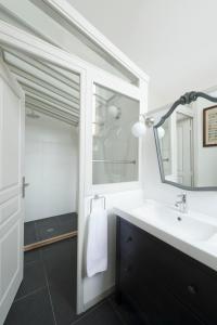 a bathroom with a sink and a mirror at Château de Martigny in Colmey +22 photos