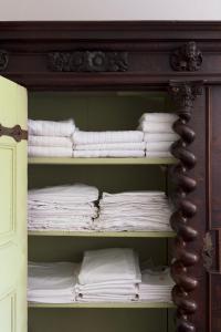 a closet filled with lots of white towels at Château de Martigny 