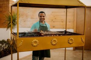 a man standing next to a food cart at Desert Moon in Cairo