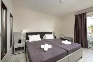 Voodi või voodid majutusasutuse Poseidon Beach Hotel toas