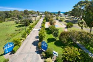 an overhead view of a road with trees and signs at Discovery Parks - Pambula Beach in Pambula