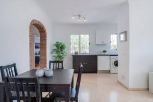 a dining room and kitchen with a table and chairs at 049 - Modern & Spacious Holiday Villa With Private Pool in Fuengirola