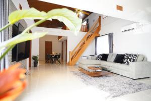 a living room with a couch and a table at ITOMAN SEA pension 大度 MIM in Ōdo