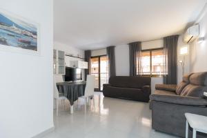 salon z kanapą i stołem w obiekcie UHC STELLA MARIS APARTMENTS w mieście Cambrils +20 zdjęć