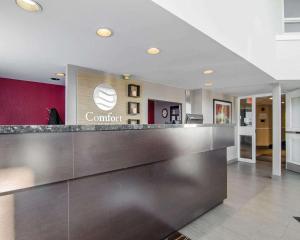 a lobby of a hotel with a reception counter at Comfort Inn in Regina