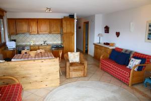a kitchen with a couch and a table in a room at Balcons du Soleil Y3 310 - QUIET appartement 6 pers in Veysonnaz