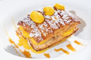 a sandwich with fruit on top of a paper at Hotel Cavalluccio Marino in Santa Marinella