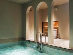 a bathroom with a large tub with two mirrors at Maison Haas Hustinx & Spa in Maastricht