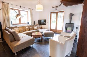 a living room with a couch and chairs and a tv at Chalet Hochkrimml 49 in Nothdorf