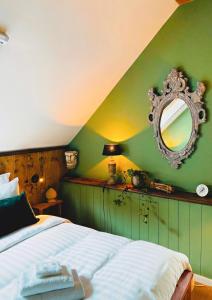 a bedroom with a bed with a mirror on the wall at Residence 1898 in Odoornerveen