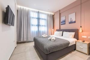 a bedroom with a bed with two stuffed animals on it at Filia Place in Athens