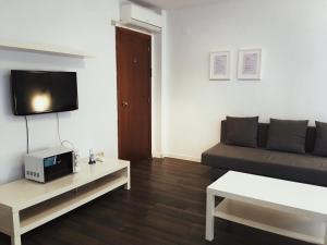 a living room with a couch and a table at Coroa Ayuntamiento in Valencia