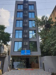 a tall building with a sign on the front of it at Nova Park in Rajkot