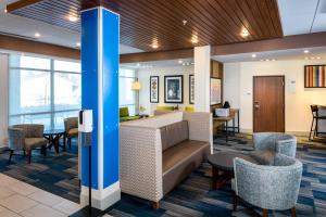 a living room filled with furniture and a large window at Holiday Inn Express & Suites - Bend South, an IHG Hotel in Bend