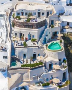 an aerial view of a resort with a swimming pool at Pezoules of Oia in Oia