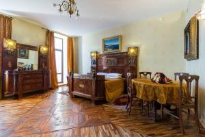 a bedroom with a bed and a table in it at Art-Hotel RACHMANINOV in Saint Petersburg