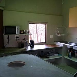 a kitchen with a sink and a window at Bush Camp Phalaborwa in Phalaborwa