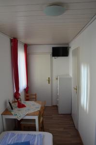 a room with a table and a room with a bed at Gasthaus Löwen in Unterreichenbach