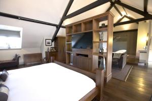 a room with a bed, a table, and a tv at Hotel Du Vin Newcastle in Newcastle upon Tyne