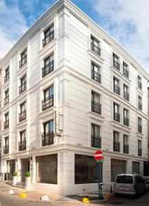 a white building with windows and a stop sign at Hotel Bossuite Business in Istanbul