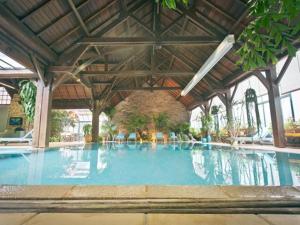 a large swimming pool in a large building at Manoir de Trégaray in Sixt-sur-Aff