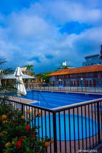 a large swimming pool next to a building at Pousada Canasvieiras ABVO in Florianópolis