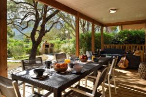 a table on a patio with a table and chairs at Résidence & Hotel U Livanti ECOLABEL in Propriano
