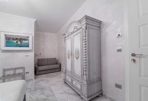 a large white cabinet in a room with a couch at Hotel Colomba D'Oro in Tropea +37 photos