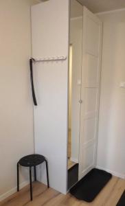 a closet with a black stool and a mirror at Kristiansund Apartments in Kristiansund