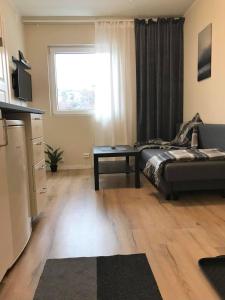 a living room with a couch and a table at Kristiansund Apartments in Kristiansund