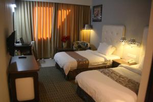 Postel nebo postele na pokoji v ubytování Ritz Garden Hotel Manjung