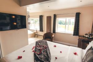 a hotel room with a bed and a dresser at The Ullswater View Guest House in Watermillock