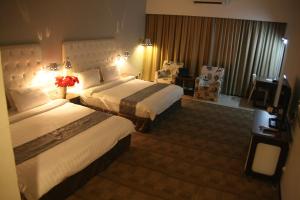 Postel nebo postele na pokoji v ubytování Ritz Garden Hotel Manjung