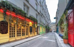 an empty city street with buildings and a store at 2066 - Duplex in Saint-Germain Olympic Games 2024 in Paris