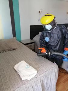 a person wearing a hard hat and a mask and a bed at Le Ciel d'Uyuni in Uyuni