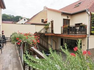 a house with flowers on the balcony at Apartmány Aranka in Žatec