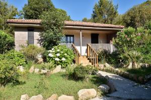 a small house with a garden in front of it at Résidence & Hotel U Livanti ECOLABEL in Propriano