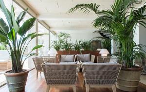 a living room with a couch and some plants at Hotel Maritim in Roses
