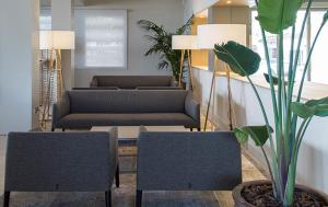 a living room with two chairs and a couch at Hotel Maritim in Roses