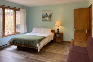 a bedroom with a large bed and a window at The Overlook in Massanuttens All Season Resort in McGaheysville