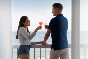 a man and a woman holding glasses of wine at Hotel Maritim in Roses