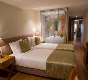a bedroom with a large bed and a bathroom at Wame Suite Hotel Nisantasi in Istanbul