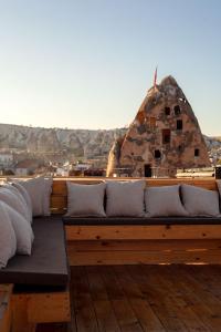 a couch sitting on top of a wooden deck at Cappadocia Cave Rooms in Göreme