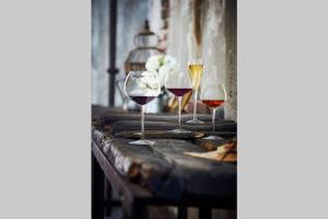 three glasses of wine sitting on a table at APPARTEMENT QUARTIER CATHEDRALE in Blois