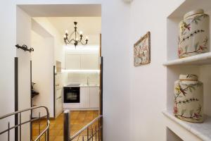 a hallway leading to a kitchen with a stairway at Hotel Villa Schuler in Taormina