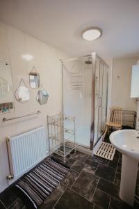a bathroom with a shower and a sink at Unique, cosy, Lake District artist hideaway - 5 bd in Millom