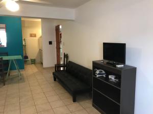 a living room with a couch and a flat screen tv at Belgrano 10 in Salta