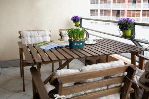 a wooden table with a book on a balcony at Appartement 2 chambres Chartrons in Bordeaux