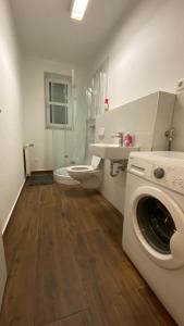 a bathroom with a washing machine and a sink at Lindenstraße in Belm